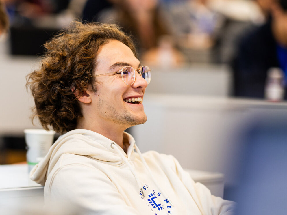 A smiling student attends a lecture on financial management at WHU